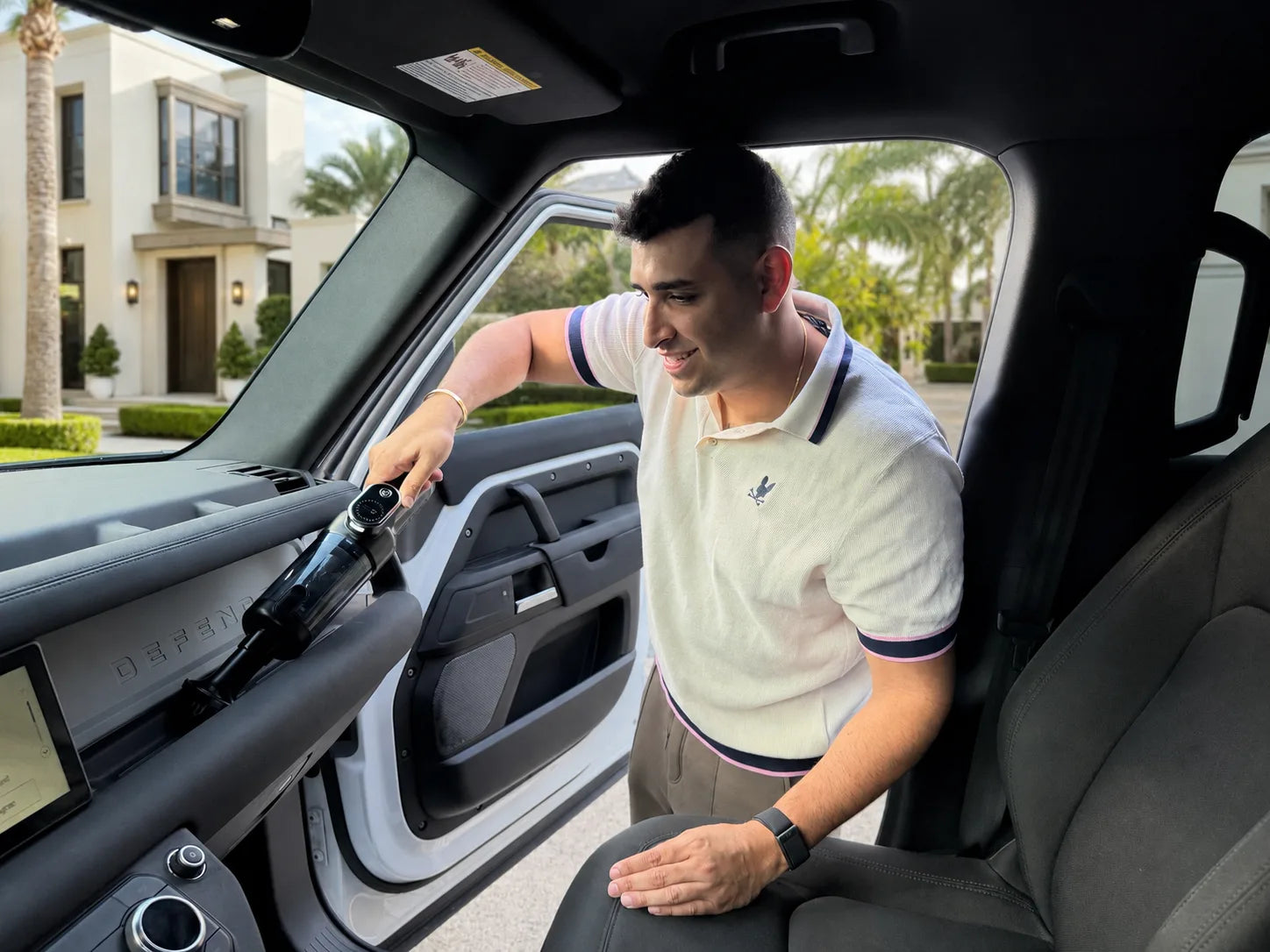 The founder of Luminoire cleaning a vehicle interior